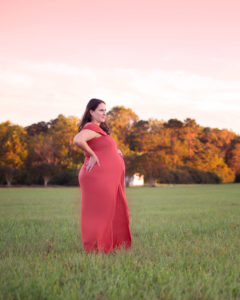 Maternity photo of a mom in a field taken in Yorktown, Virginia